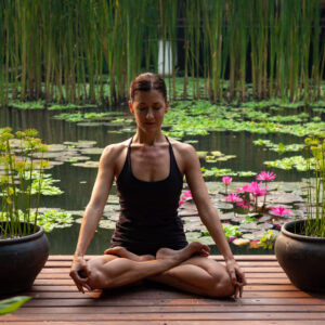 Image of yogi woman sitting in lotus pose in meditation